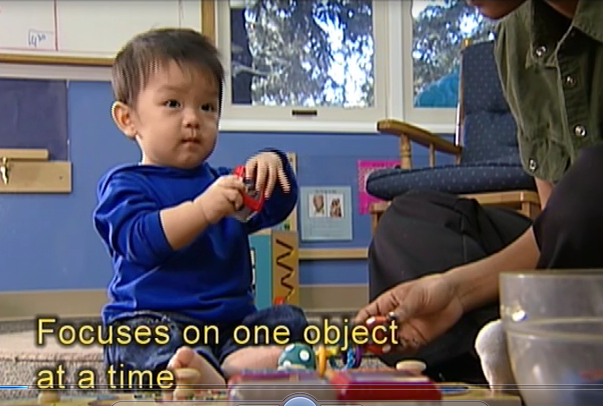 infant playing with puzzle