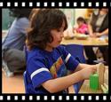 child with rock in science center