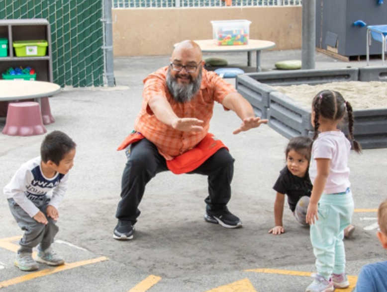 Teacher and children outside