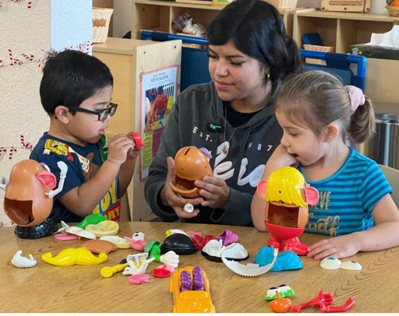 Teacher and children with legos
